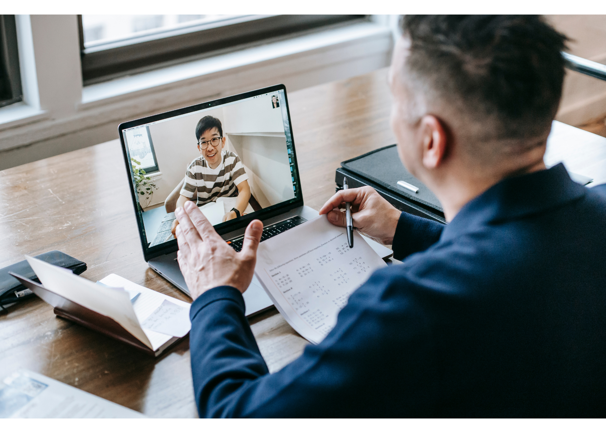 Stock photo of man talking on laptop